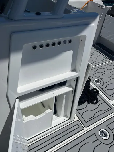  Yacht Photos Pics 2021 Edgewater 340CC boat interior with open storage compartment and non-slip deck.