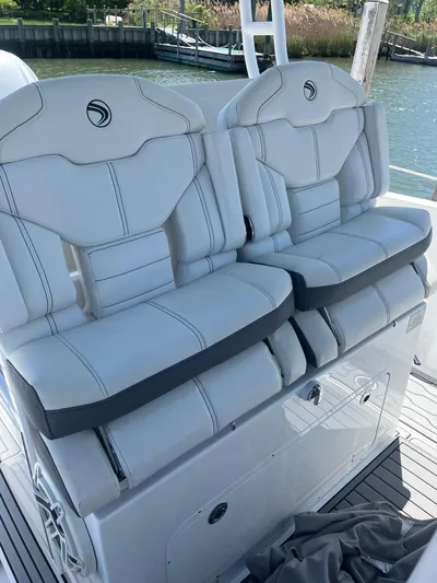  Yacht Photos Pics 2021 Edgewater 340CC boat seats with white upholstery and sleek design.