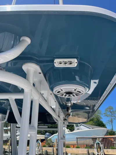  Yacht Photos Pics 2021 Edgewater 340CC boat with blue hull, featuring speakers and lights underneath.