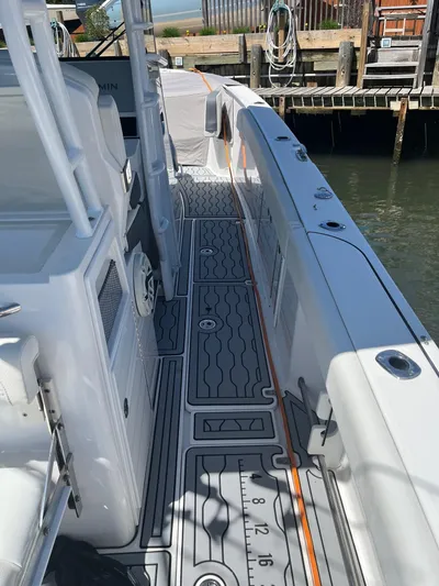  Yacht Photos Pics 2021 Edgewater 340CC boat deck with sleek design and modern features, docked by the water.