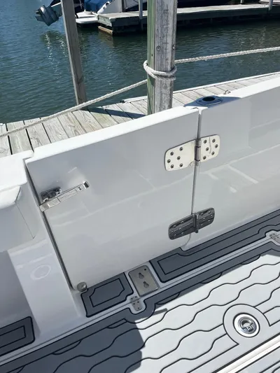  Yacht Photos Pics 2021 Edgewater 340CC boat with open side door, docked by the water.