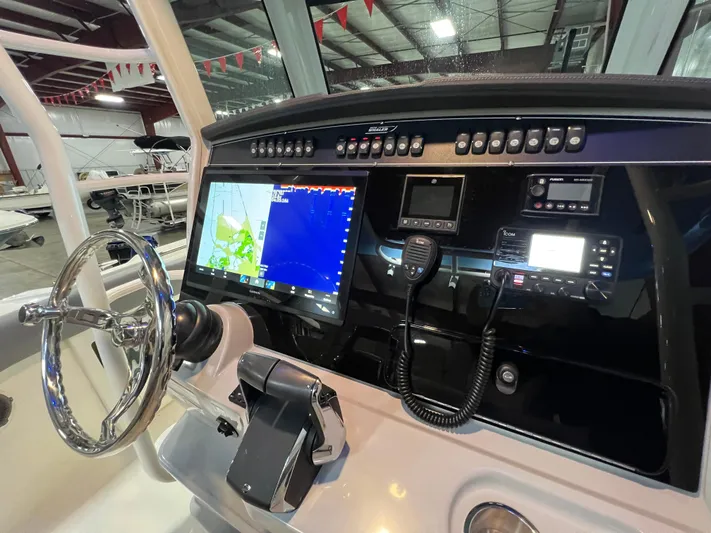  Yacht Photos Pics 2022 Boston Whaler 330 Outrage helm with advanced navigation and control systems.