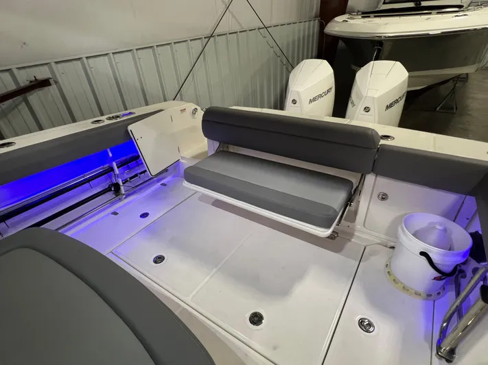  Yacht Photos Pics 2022 Boston Whaler 330 Outrage boat interior with seating and dual Mercury engines.