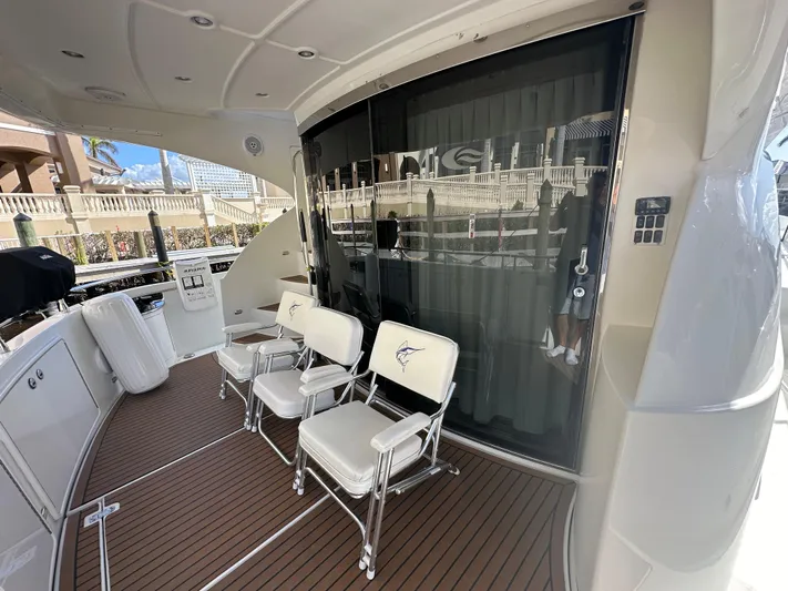 La Vida Loca Yacht Photos Pics 2004 Marquis 59 yacht deck with white chairs and sleek design.