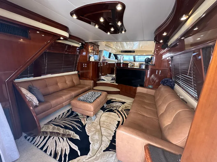 La Vida Loca Yacht Photos Pics Luxurious 2004 Marquis 59 yacht interior with leather sofas and elegant wood finishes.