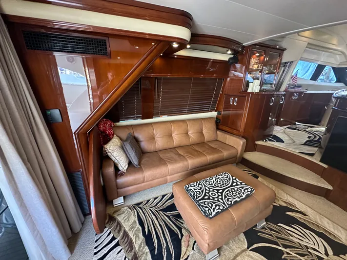 La Vida Loca Yacht Photos Pics Luxurious 2004 Marquis 59 yacht interior with leather sofa and elegant wood finishes.