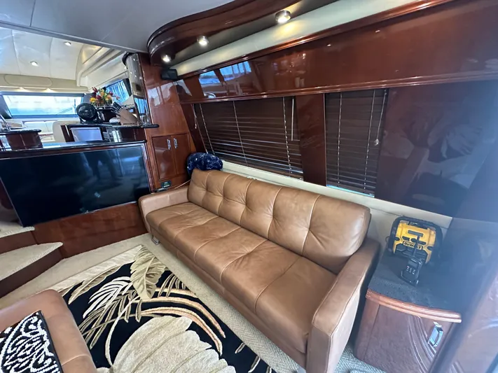 La Vida Loca Yacht Photos Pics Luxurious interior of a 2004 Marquis 59 yacht with leather sofa and modern decor.