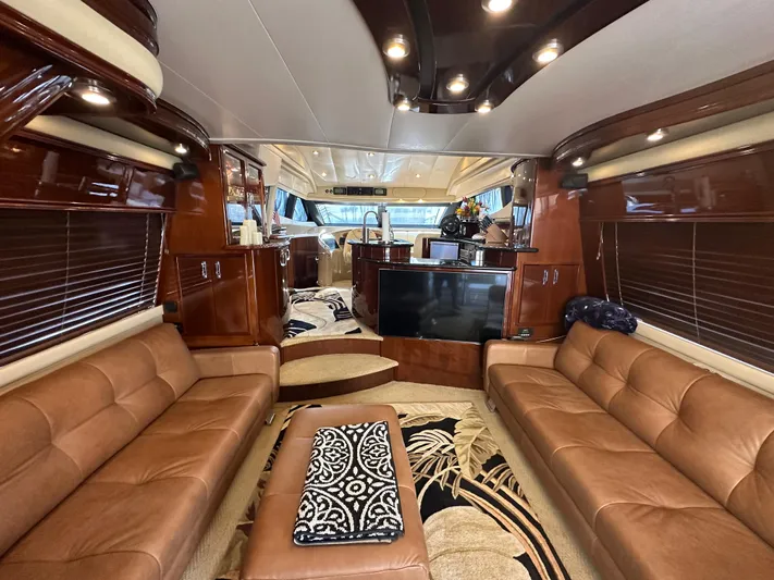 La Vida Loca Yacht Photos Pics Luxurious interior of a 2004 Marquis 59 yacht with leather seating and elegant wood finishes.