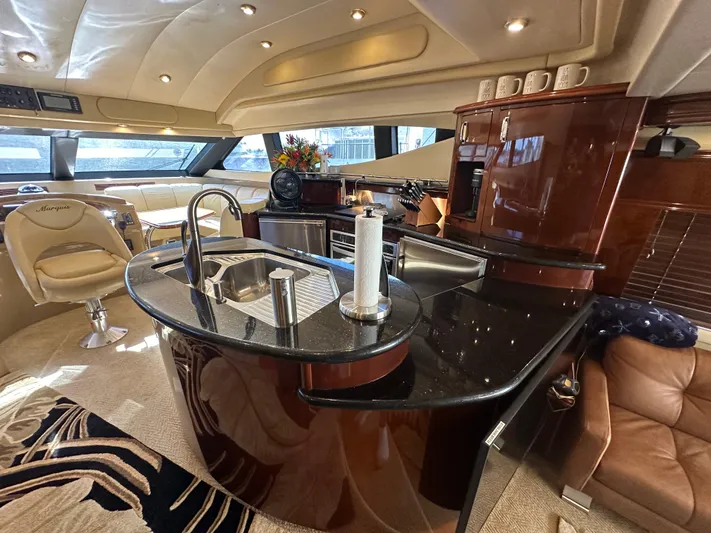 La Vida Loca Yacht Photos Pics Luxurious 2004 Marquis 59 yacht interior with modern kitchen and elegant seating.