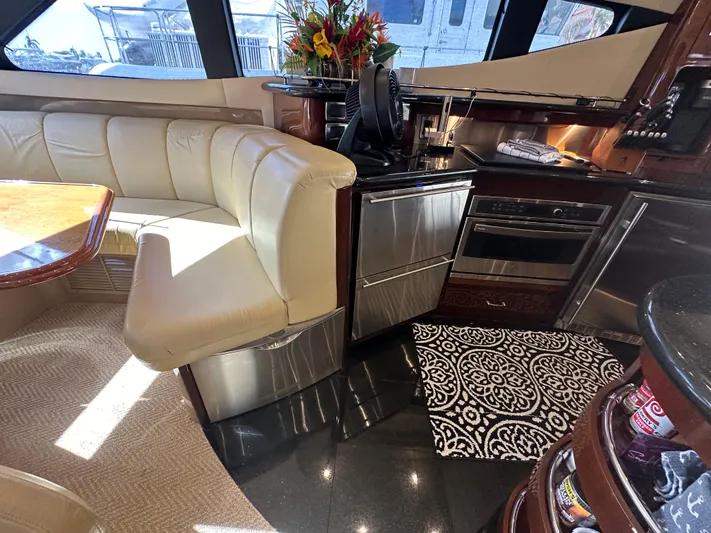La Vida Loca Yacht Photos Pics Luxurious interior of a 2004 Marquis 59 yacht with modern kitchen and seating area.