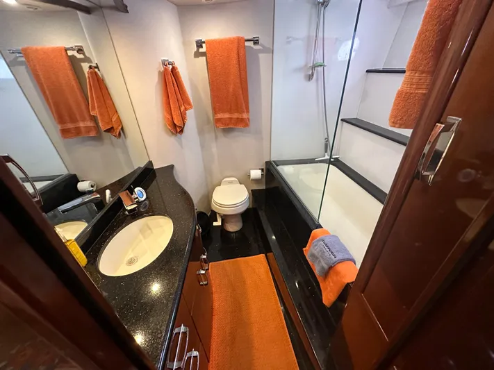 La Vida Loca Yacht Photos Pics Luxurious 2004 Marquis 59 yacht bathroom with orange accents and modern fixtures.