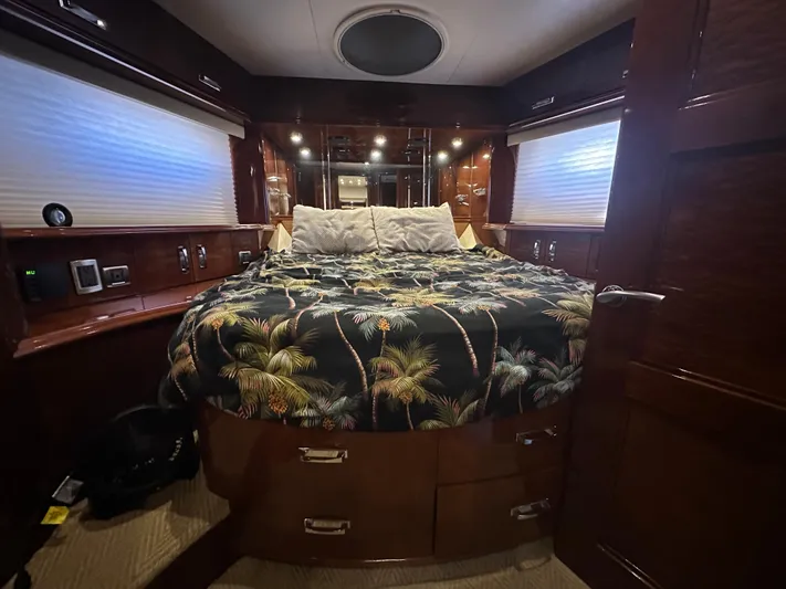 La Vida Loca Yacht Photos Pics Luxurious 2004 Marquis 59 yacht bedroom with tropical-themed bedding and elegant wood finishes.