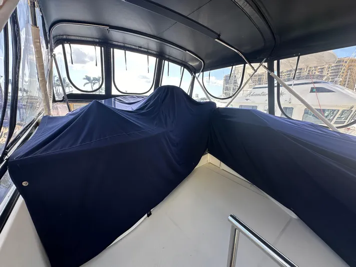 La Vida Loca Yacht Photos Pics 2004 Marquis 59 yacht interior with blue covers and panoramic windows.