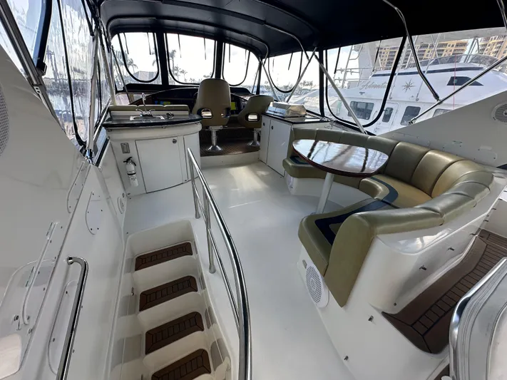 La Vida Loca Yacht Photos Pics Luxurious 2004 Marquis 59 yacht interior with seating and helm area.