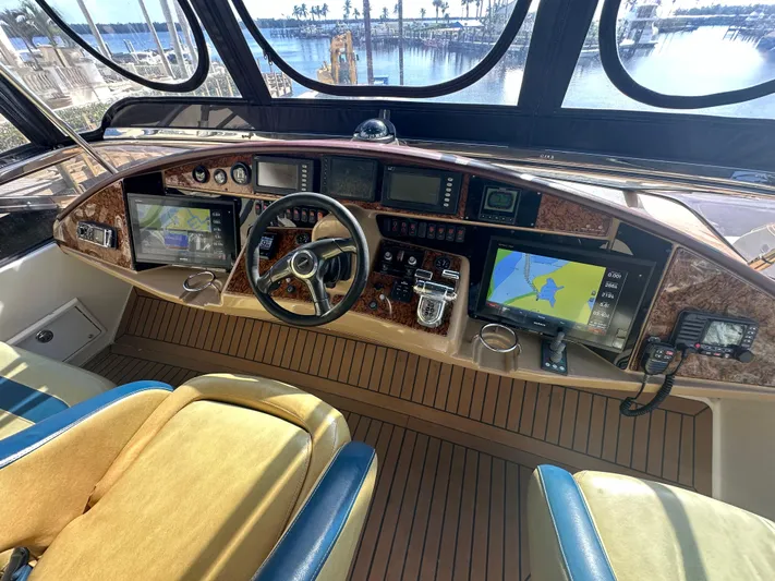 La Vida Loca Yacht Photos Pics Luxurious 2004 Marquis 59 yacht helm with advanced navigation systems and elegant wood finish.