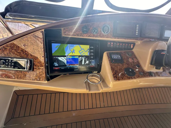 La Vida Loca Yacht Photos Pics 2004 Marquis 59 yacht dashboard with navigation system and wood finish.