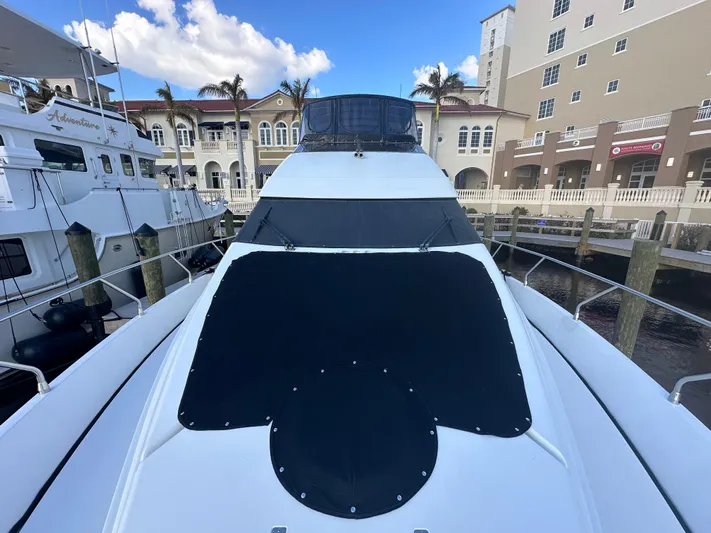 La Vida Loca Yacht Photos Pics 2004 Marquis 59 yacht docked at marina with clear blue sky.