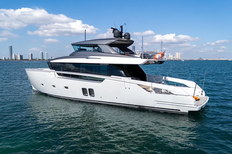 Vasiliki Yacht Photos Pics 2019 Sanlorenzo SX76 yacht cruising on blue water with city skyline in background.