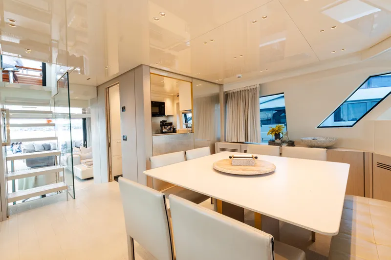 Vasiliki Yacht Photos Pics Luxurious interior of 2019 Sanlorenzo SX76 yacht with modern dining area and elegant decor.