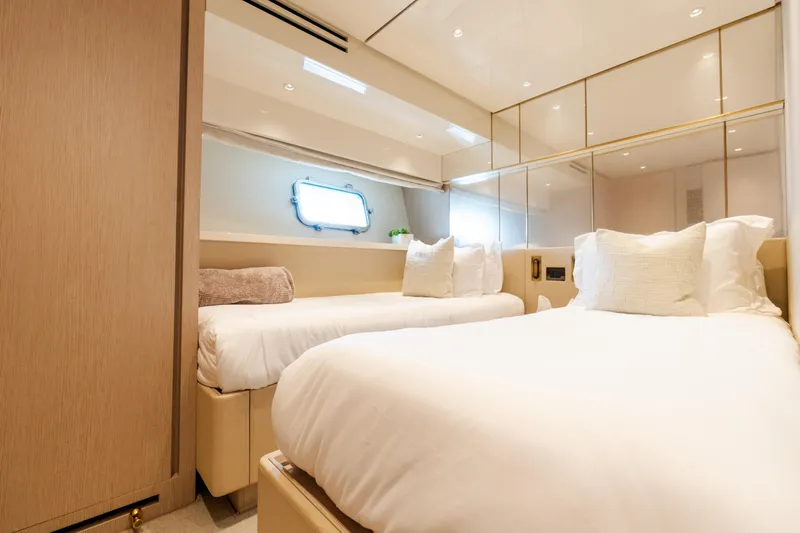 Vasiliki Yacht Photos Pics Luxurious twin bedroom on 2019 Sanlorenzo SX76 yacht, featuring elegant decor and soft lighting.