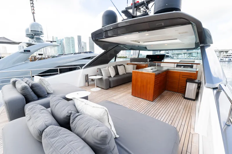 Vasiliki Yacht Photos Pics Luxurious 2019 Sanlorenzo SX76 yacht deck with modern seating and city skyline view.