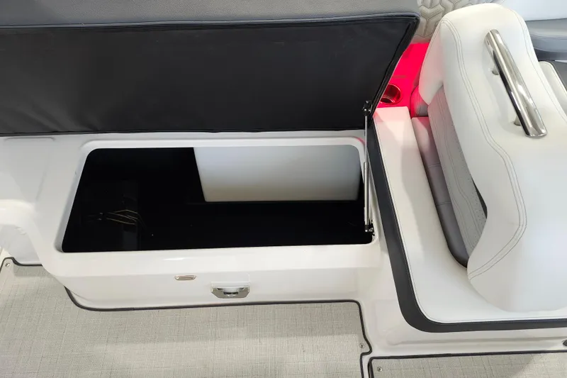  Yacht Photos Pics 2025 Regal LX6 boat storage compartment with open lid and seating area.