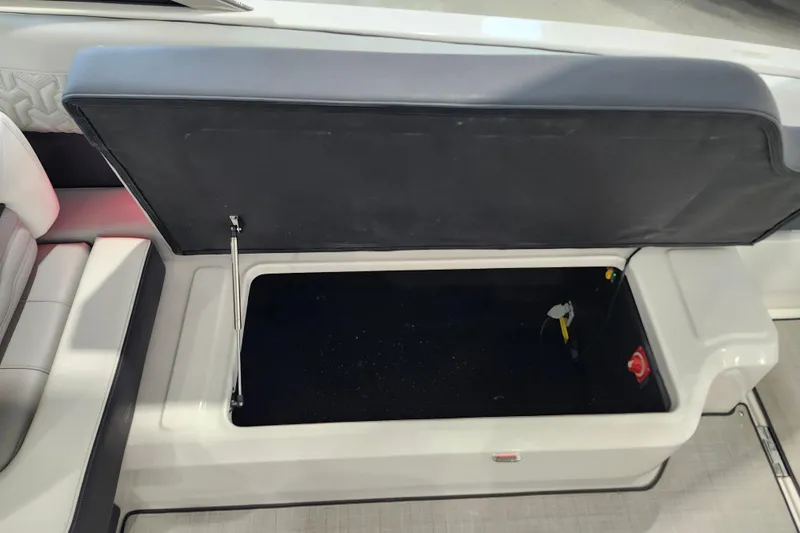  Yacht Photos Pics Open storage compartment in 2025 Regal LX6 boat, showcasing spacious interior design.