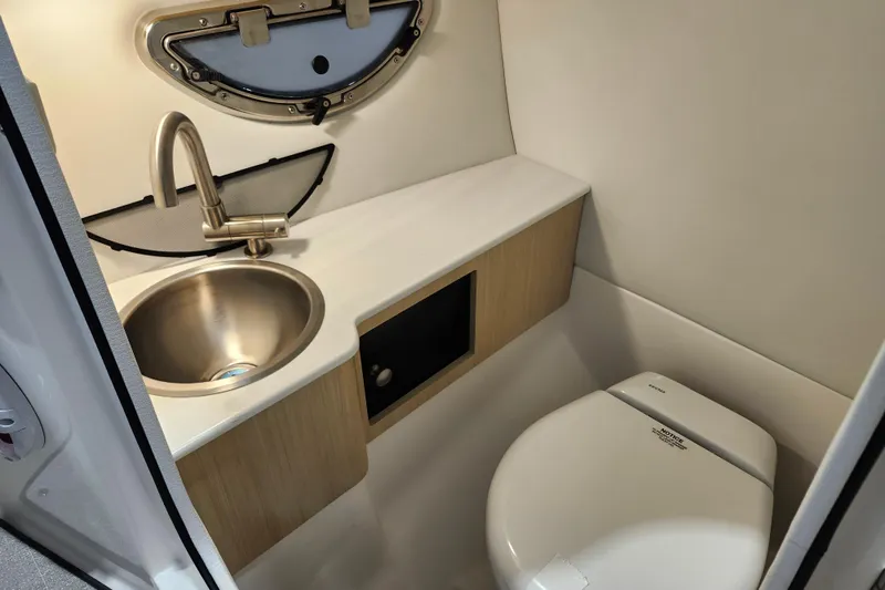  Yacht Photos Pics 2025 Regal LX6 boat bathroom with stainless steel sink and modern toilet.