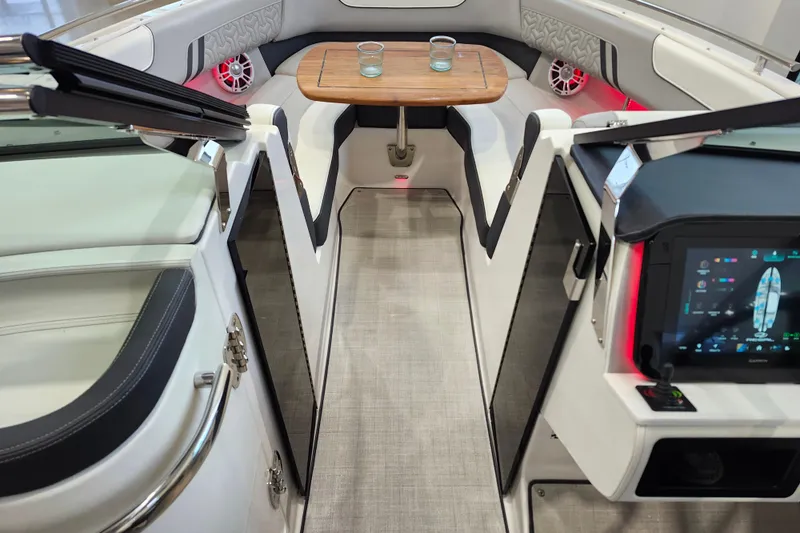  Yacht Photos Pics 2025 Regal LX6 boat interior with modern dashboard, seating, and wooden table.