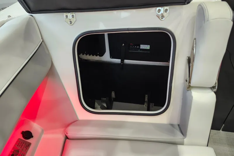  Yacht Photos Pics 2025 Regal LX6 boat interior storage compartment with red ambient lighting.