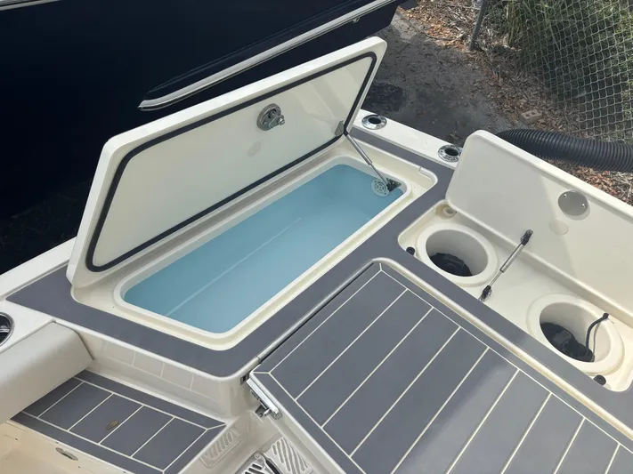  Yacht Photos Pics 2025 Scout 281 XSS boat with open storage compartments and cup holders.