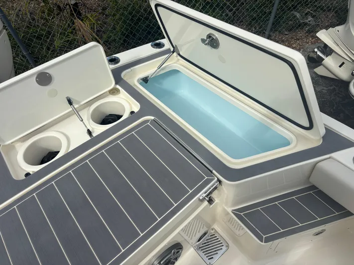  Yacht Photos Pics 2025 Scout 281 XSS boat with open storage compartments and cup holders.