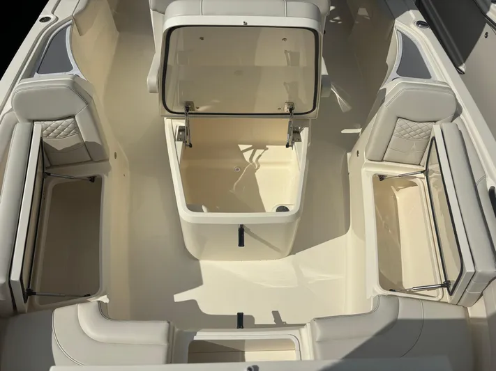  Yacht Photos Pics 2025 Scout 281 XSS boat interior with open storage compartments and cushioned seating.