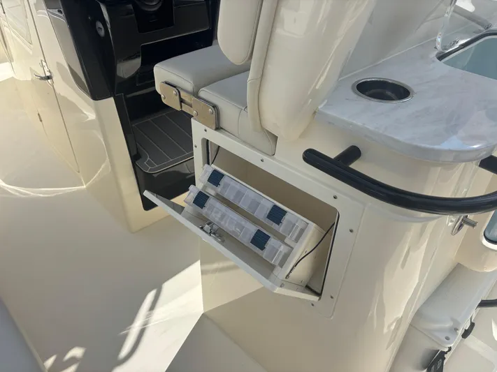  Yacht Photos Pics 2025 Scout 281 XSS boat interior with storage compartment and seating.