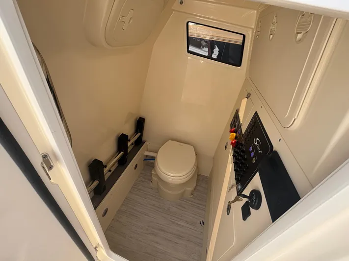  Yacht Photos Pics 2025 Scout 281 XSS boat interior bathroom with toilet and control panel.