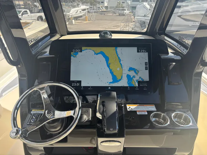  Yacht Photos Pics 2025 Scout 281 XSS boat dashboard with navigation display and steering wheel.
