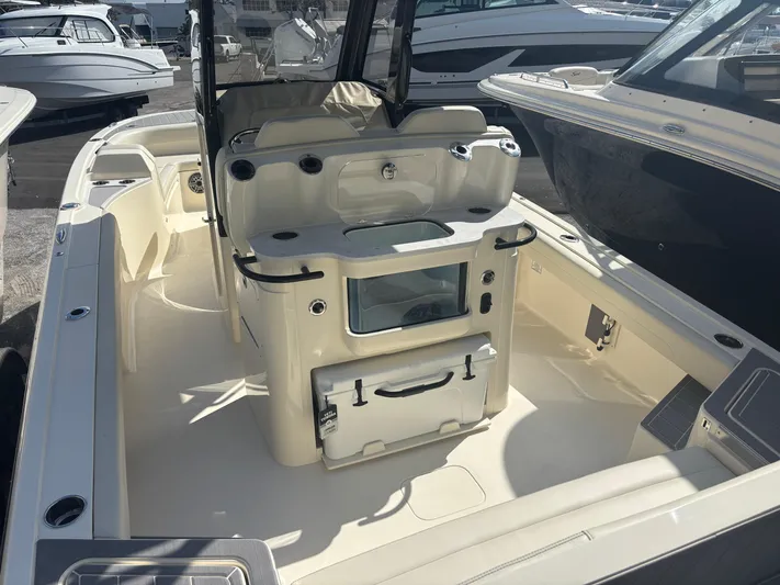 Yacht Photos Pics 2025 Scout 281 XSS boat interior with seating and storage compartments.