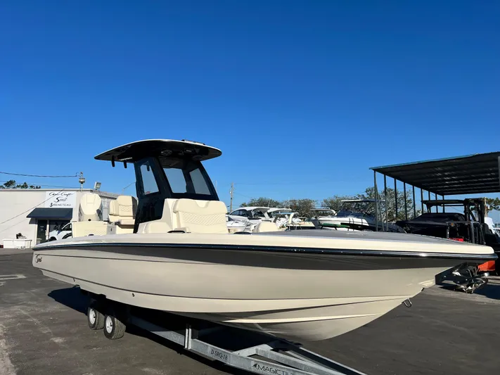  Yacht Photos Pics 2025 Scout 281 XSS boat on trailer under clear blue sky.