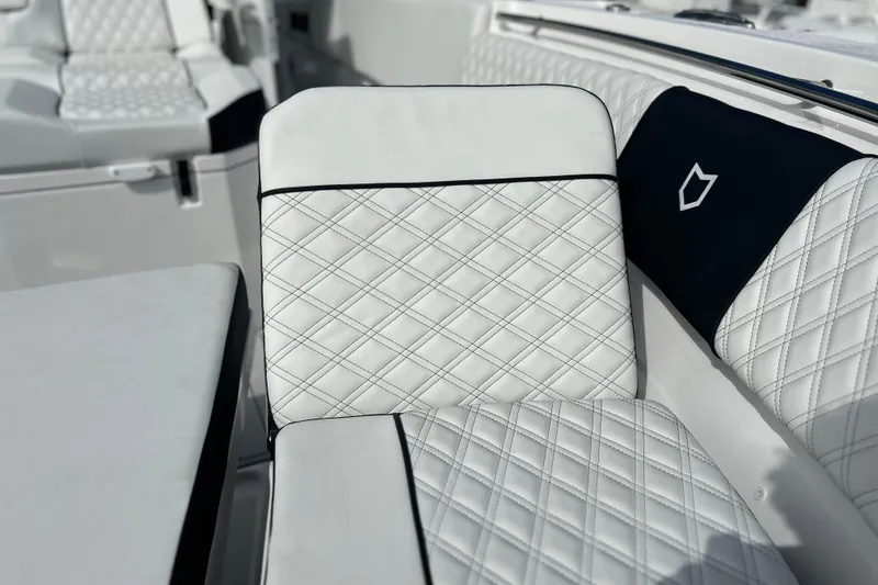  Yacht Photos Pics Luxurious white seating on 2026 Sea Fox 368 Commander boat, featuring diamond stitching.
