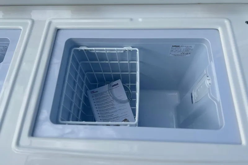  Yacht Photos Pics Open storage compartment on 2026 Sea Fox 368 Commander boat with basket and manual.