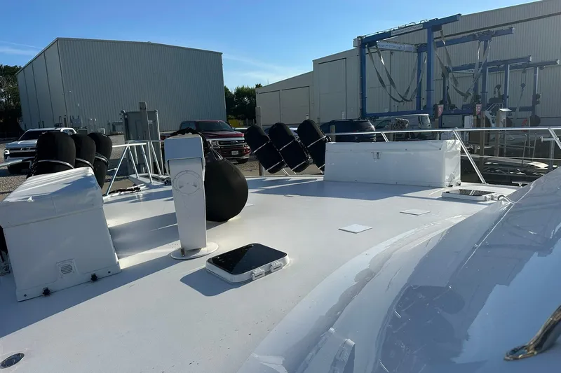 So Blessed Yacht Photos Pics 1998 Viking 54 Motor Yacht deck view at a marina with equipment and vehicles.