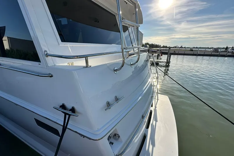 So Blessed Yacht Photos Pics 1998 Viking 54 Motor Yacht docked under sunny skies.