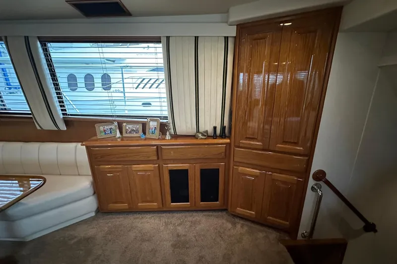 So Blessed Yacht Photos Pics Interior of 1998 Viking 54 Motor Yacht with wood cabinetry and large windows.