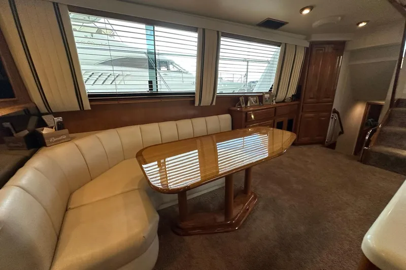 So Blessed Yacht Photos Pics Interior of 1998 Viking 54 Motor Yacht with elegant seating and wooden table.