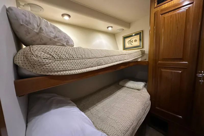 So Blessed Yacht Photos Pics Bunk beds in 1998 Viking 54 Motor Yacht cabin with cozy lighting and wooden accents.