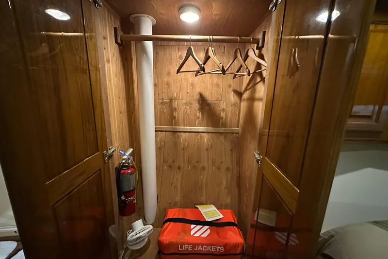 So Blessed Yacht Photos Pics Wooden closet interior on a 1998 Viking 54 Motor Yacht with life jackets and hangers.