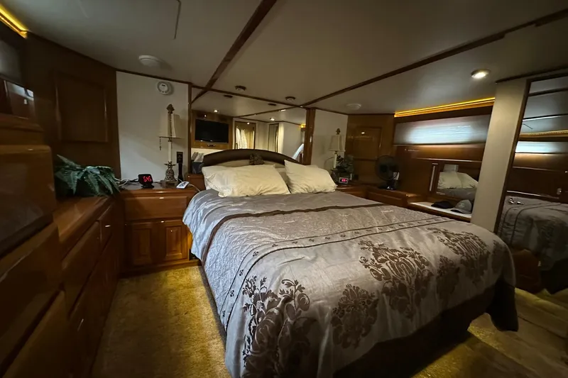 So Blessed Yacht Photos Pics Luxurious bedroom interior of 1998 Viking 54 Motor Yacht with elegant bedding and wood accents.