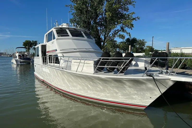 So Blessed Yacht Photos Pics 1998 Viking 54 Motor Yacht docked in a serene marina setting.