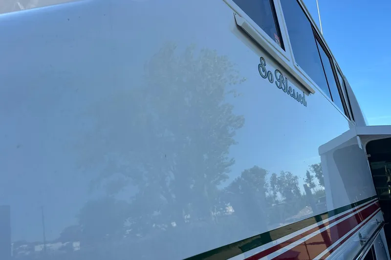 So Blessed Yacht Photos Pics Side view of a 1998 Viking 54 Motor Yacht with "So Blessed" inscription.