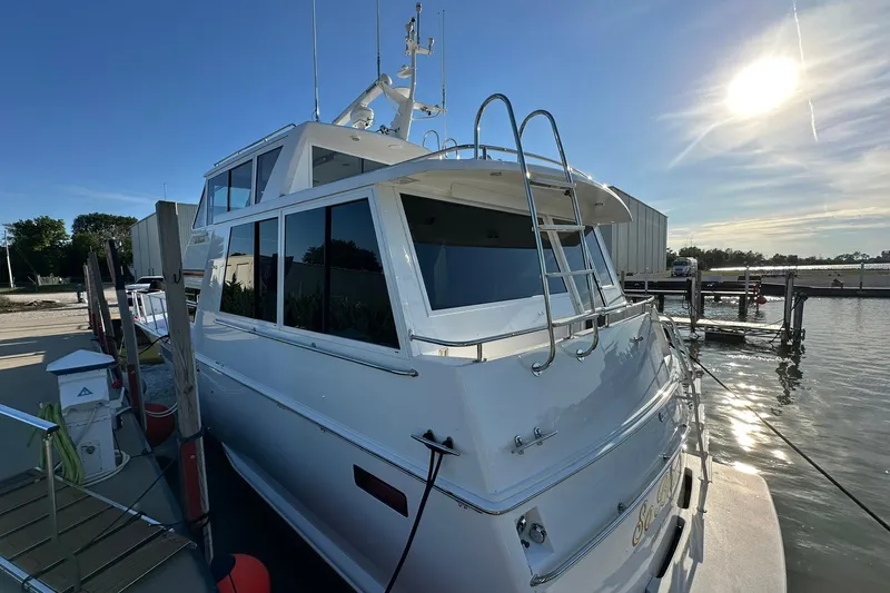 So Blessed Yacht Photos Pics 1998 Viking 54 Motor Yacht docked, sunlit, with sleek design and modern features.